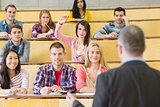 Elegant teacher with students at the lecture hall