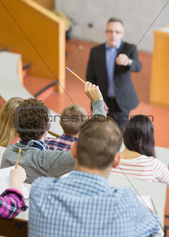 Students with teacher at lecture hall