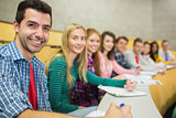 Smiling students in a row at the lecture hall