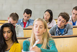 Concentrating students sitting at lecture hall