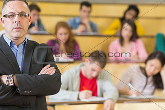 Portrait of an elegant teacher with students at lecture hall