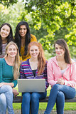 Young college girls with laptop in park