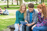 College students using tablet PC in park