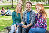 College students with tablet PC in park