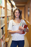 Smiling female student standing in the library