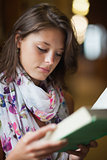 Close up of a beautiful female student reading a book