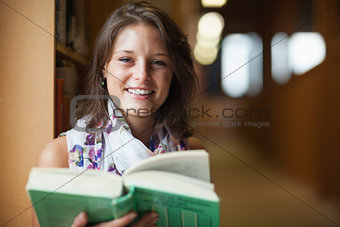 Close up of a smiling female student in library