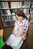 Female student reading a book in the library