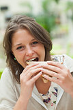 Female student eating sandwich in the cafeteria