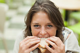Close up portrait of a female student eating sandwich