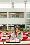 Gloomy student in the cafeteria with food tray