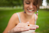 Close up of a blurred woman gently holding a ladybug