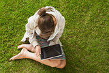Woman using tablet PC at the park