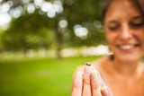 Smiling blurred woman gently holding a ladybug