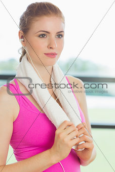 Woman with towel around neck listening to music
