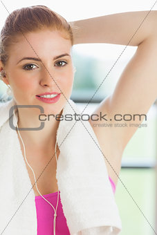 Woman with towel around neck listening to music