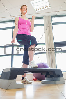 Young woman at aerobics class in gym