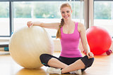 Fit beautiful woman with exercise ball in fitness studio