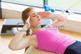 Determined woman working out with exercise ball