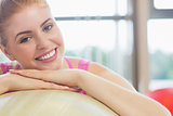 Close up of a beautiful woman leaning on exercise ball