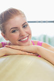 Close up of a beautiful woman leaning on exercise ball