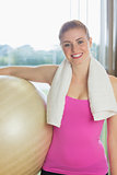 Fit beautiful woman carrying exercise ball