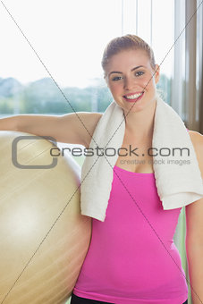 Fit beautiful woman carrying exercise ball
