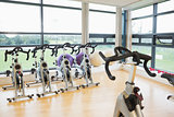 Spinning exercise bikes in gym room