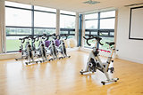 Spinning exercise bikes in gym room