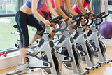 Mid section of people working out at spinning class
