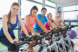 Five people working out at spinning class