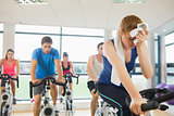 Tired people working out at spinning class