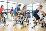 Determined people working out at spinning class