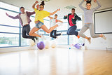 Fit people jumping in exercise room