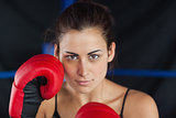 Close up portrait of a beautiful woman in red boxing gloves