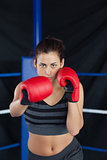 Portrait of a beautiful woman in red boxing gloves