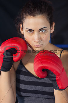 Close up of a beautiful woman in red boxing gloves