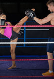 Female boxer practicing an air kick