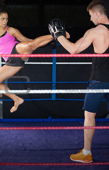 Female boxer practicing an air kick