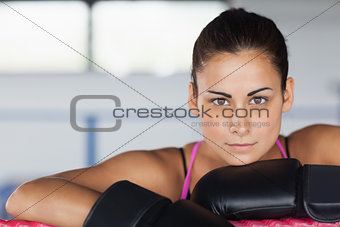 Beautiful young woman in black boxing gloves
