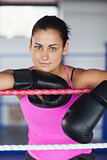 Portrait of a beautiful woman in black boxing gloves