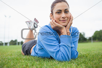 Pretty young woman lying on the grass