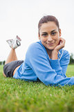 Pretty young woman lying on the grass