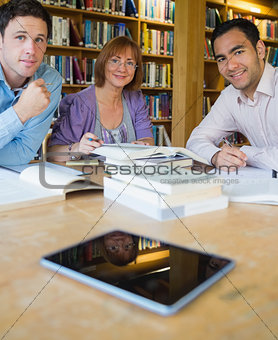 Mature students studying together in the library