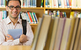 Smiling mature student with tablet PC in library