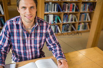 Mature male student studying at desk in the library