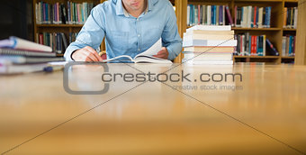 Mid section of a mature student at library desk