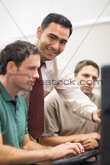 Teacher and mature student in computer room