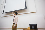 Teacher with projection screen in lecture hall