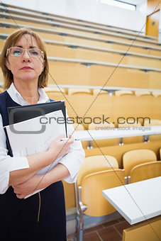 Serious elegant teacher standing in the lecture hall